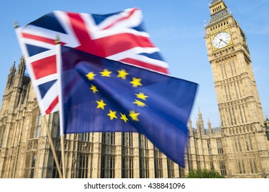 European Union And British Union Jack Flag Flying In Motion Blur In Front Of Big Ben And The Houses Of Parliament At Westminster Palace, London, In Preparation For The Brexit EU Referendum