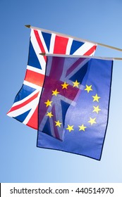 European Union And British Union Jack Flag Flying Backlit In Front Of Bright Blue Sky In Preparation For The Brexit EU Referendum