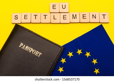 European Union Concept Showing The Flag Of The EU And A Passport On A Yellow Background With A Sign Reading EU Settlement