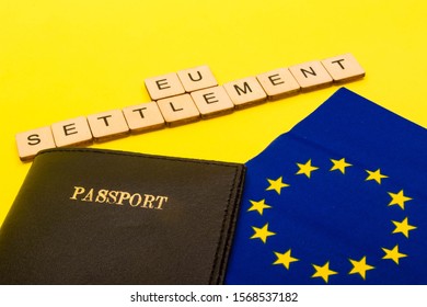 European Union Concept Showing The Flag Of The EU And A Passport On A Yellow Background With A Sign Reading EU Settlement