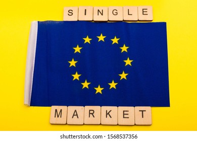 European Union Concept Showing The Flag Of The EU On A Yellow Background With A Sign Reading Single Market