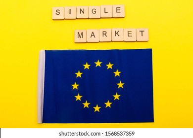 European Union Concept Showing The Flag Of The EU On A Yellow Background With A Sign Reading Single Market