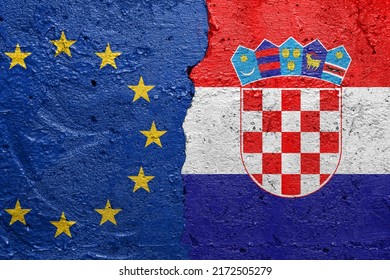 European Union EU and Croatia - Cracked concrete wall painted with a EU flag on the left and a Croatian flag on the right