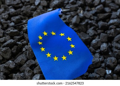 European Union flag against the background of coal, Concept, coal mining in EU countries, Rising commodity prices in the world, Environmental impact, Industry and economy of the Community - Shutterstock ID 2162547823