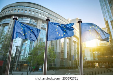 European union flag against parliament in Brussels, Belgium - Shutterstock ID 253692781