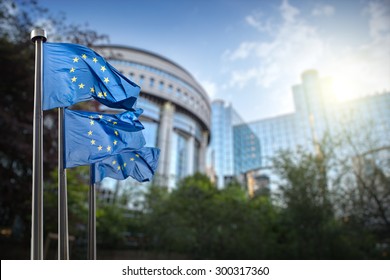 European union flag against parliament in Brussels, Belgium - Shutterstock ID 300317360