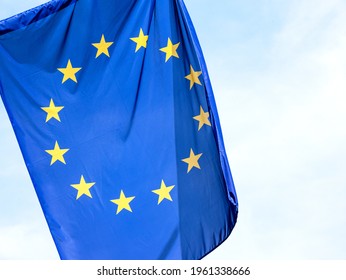 European Union Flag, EU Symbol Part Up Close, 12 Stars Flag Object Detail, Closeup, Clear Sky In The Background, Nobody. Politics, Economy, Business And EU, Europe Culture, Laws Abstract Concept