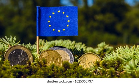 European Union Flag With Euro Coins Amid Moss,recovery Fund Business,finance And Economy Concept,macro Close Up