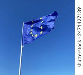 European union flag flutters in the wind on blue sky background, Travel and tourism in European union concept, European parliament elections June 9, 2024, closeup