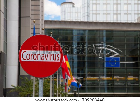 European Union parlament with flagpoles and Covid sign, coronavirus lockdown concept