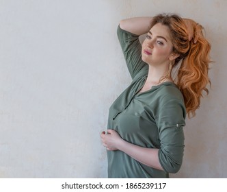European woman 35 years old isolated on a light background.A girl with long red hair and freckles. Bright appearance. large facial features.background. copy space. russian