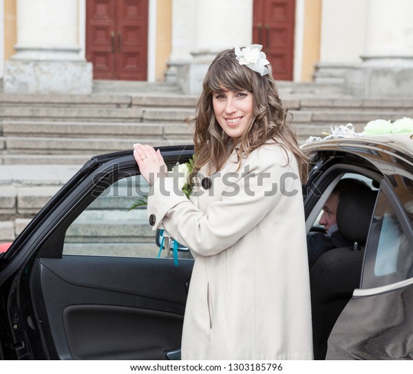 European woman getting in rear seat of luxury car\
with driver, vip\
person