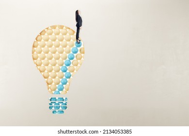 European woman in suit standing on abstract pattern light bulb on light background with mock up place. Idea, growth and success concept