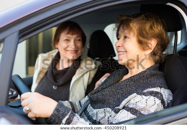 european women\
driving in European city and\
talking