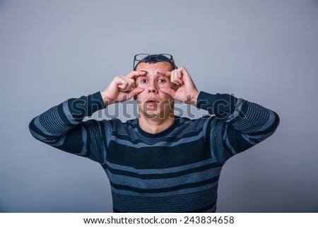 Similar – Man observing something through binoculars