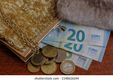 Euros Spilling Out Of Evening Bag With Edge Of Mink Stole