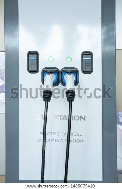 EV Car Charger. Electric car. Charging Station\
with the power cable. Technology car.  Future transport.\
Recharging. High technology . Transportation EV. Transport EV car.\
Innovation future.