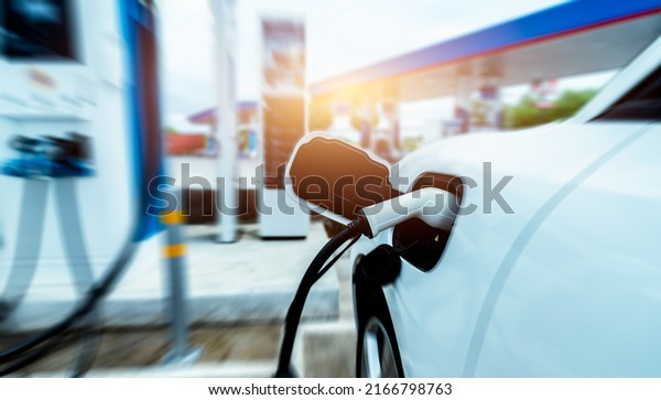 EV car charging at outdoor electric car charging\
station. EV car charging point. Electric vehicle fast charge\
concept. DC fast charging station. Quick charge concept.\
Sustainable power. Green\
energy.