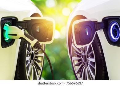 EV Car or Electric car charging on parking lot with electric car charging station / Electric cars in the row ready for drive. - Shutterstock ID 756696637