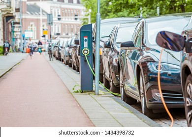 EV Car or Electric car at charging station with the power cable supply plugged in Amsterdam, Holland
