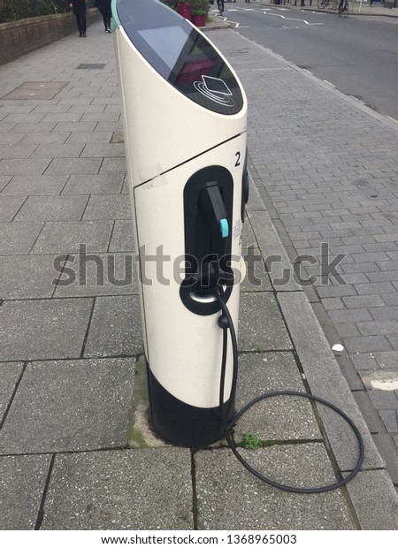 EV\
Car or Electric car at charging station with the power cable supply\
plugged in  Eco-friendly alternative energy concept\
