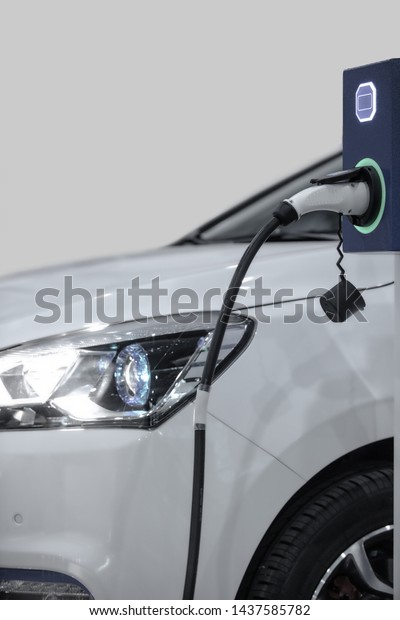EV\
Car or Electric car at charging station with the power cable supply\
plugged in. Eco-friendly alternative energy\
concept
