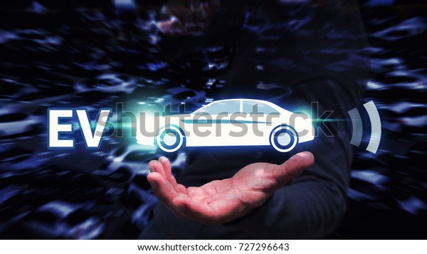 EV car, electric car in hand plug in charger\
for green electric energy ,Business man hold EV car icon for energy\
save and future technology