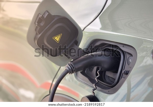 EV\
Charger plug charging EV car, New technology trend electricity\
vehicles for sustainaility and lobal warming\
issue