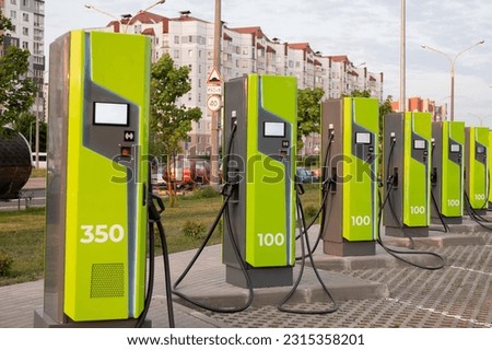 EV charges the electric vehicle. A power source for charging an electric vehicle. Socket for a car charger. Charging station for electric vehicles in the parking lot. Natural energy