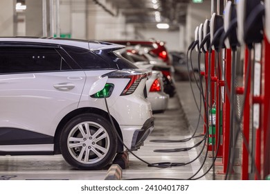 EV charging and electric car, Electric car charging station for charge EV battery, Plug for vehicle with electric engine, EV charger clean energy, Charging point at car parking lot. - Powered by Shutterstock