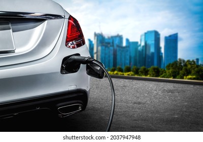 EV charging station for electric car in concept of green energy and eco travel . The electric power is produced from sustainable resource to supply to charger station in order to reduce CO2 emission . - Shutterstock ID 2037947948