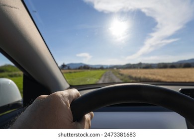EV driving point of view on a country road in sunshine