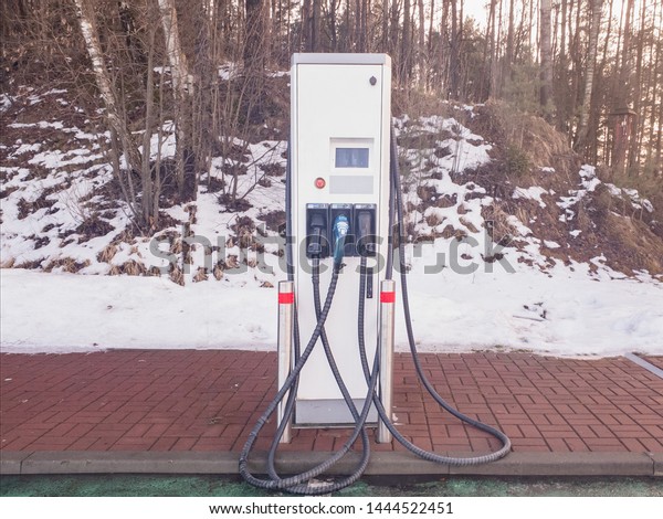EV\
Electric car charging station. Snow on the\
background