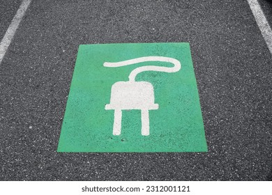 EV Electric Vehicle Parking Spot Symbol - Space Reserved for Plug-in Electric Cars to Recharge