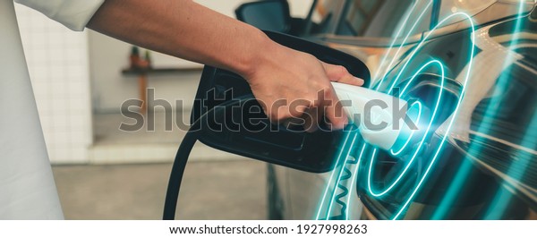 EV electronic vehicle electric hybrid car\
power charging station with display futuristic UI uses power supply\
cable charging, modern industry mode of automobile transportable\
eco friendly environment.