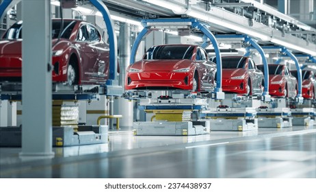 EV Production Line on Advanced Automated Smart Factory. High Performance Electric Car Manufacturing. Car Batteries Installation on Electric Vehicles on Assembly line. Automotive Plant.