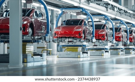 EV Production Line on Advanced Automated Smart Factory. High Performance Electric Car Manufacturing. Car Batteries Installation on Electric Vehicles on Assembly line. Automotive Plant.