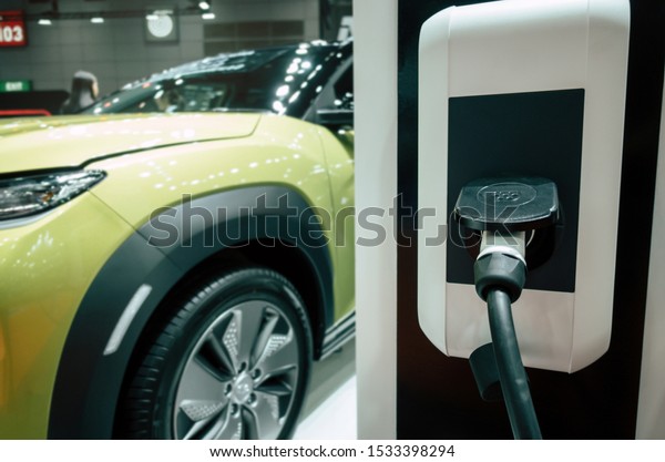 EV Tech. power supply connect station for\
electric vehicle battery charge for future, electric car,\
technology transport industry, hybrid car, power saving, global\
warming and automobile\
concept