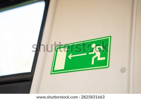 Evacuation exit sign on the wall in the train car