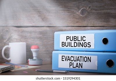 Evacuation Plan And Public Buildings. Two Binders On Desk In The Office. Work And Fire Safety Concept