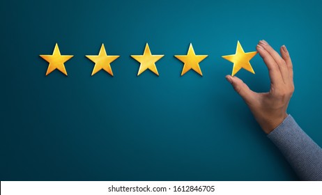 Evaluation concept. Business woman holding five star to increase rating of company, panorama, copy space