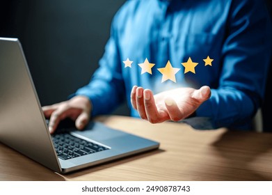 evaluation, feedback, five, goal, increase, management, marketing, satisfaction, score, performance. A man is holding a laptop and has five stars on it. The laptop is on a wooden table.