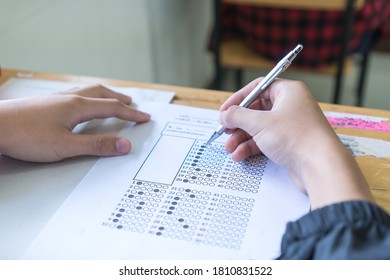 Evaluation or measurement concept. Student testing in exercise taking fill in exam at school or university in test room, writing document exams paper at campus classroom, education back to school idea