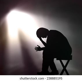 Evangelism concept: The lonely man in dark room with spiritual light background