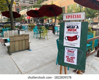 Evanston, IL/USA-September 27 2020: Signs Outside Colectivo Coffee House Communicate Guidelines For Mask Wearing And Social Distancing In Outdoor Patio Dining Area.