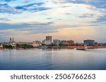 Evansville, Indiana, USA downtown city skyline on the Ohio River at dusk.