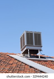Evaporative air conditioner on top of tiled roof
