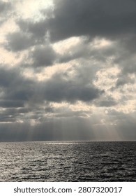 Even the darkest clouds can’t stop the light from reaching the sea. Sometimes, hope shines brightest through the smallest opening.