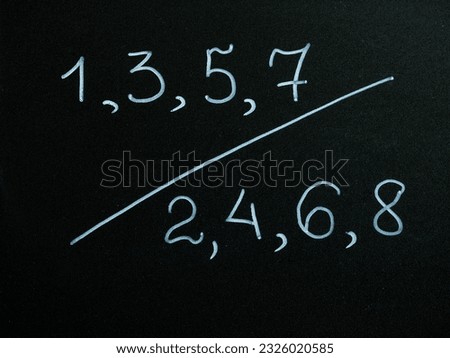 even and odd numbers drawing by chalk on black board background