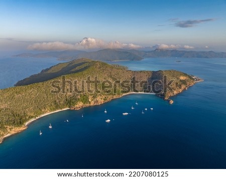Evening aerial drone view of Hayman Island, the most northerly of the Whitsunday Islands in Queensland, Australia, near the Great Barrier Reef. Blue Pearl Bay in foreground, Hook Island in the back.